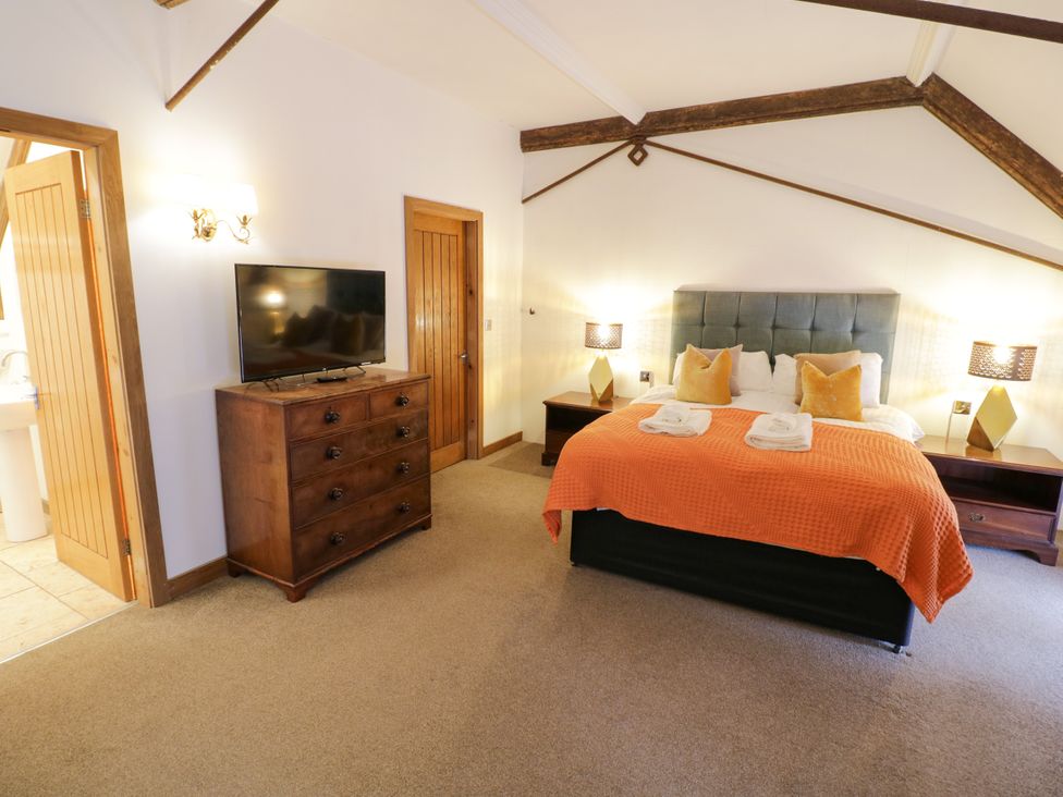 A bedroom with a bed and TV at Talbot Lodge Ingestre near Great Haywood