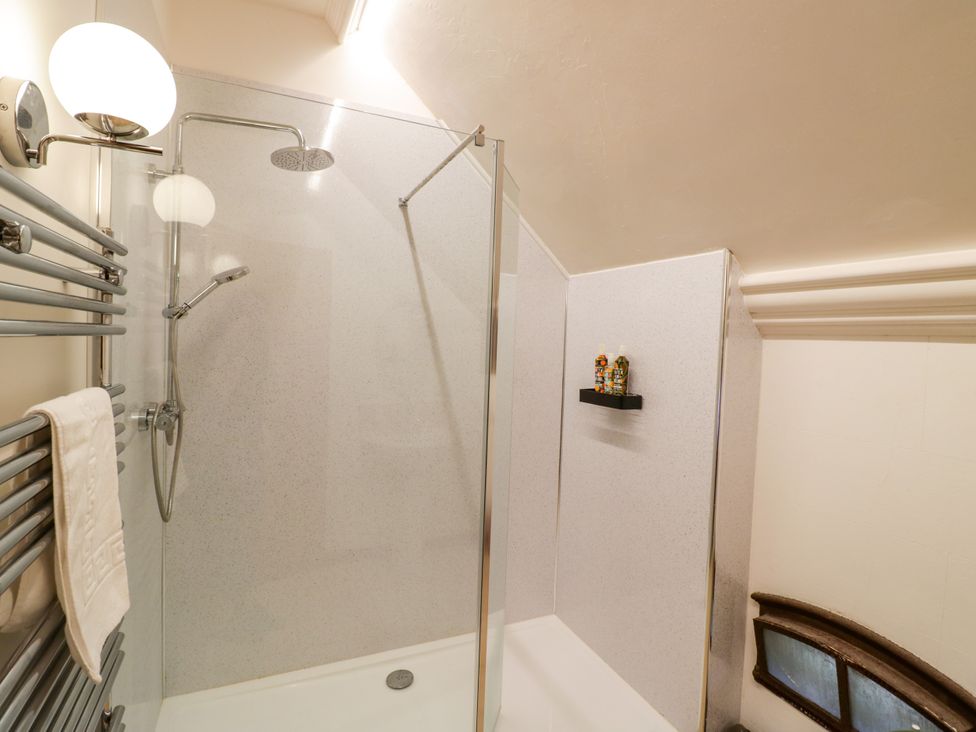 A bathroom with a shower and towel rack at Talbot Lodge Ingestre near Great Haywood
