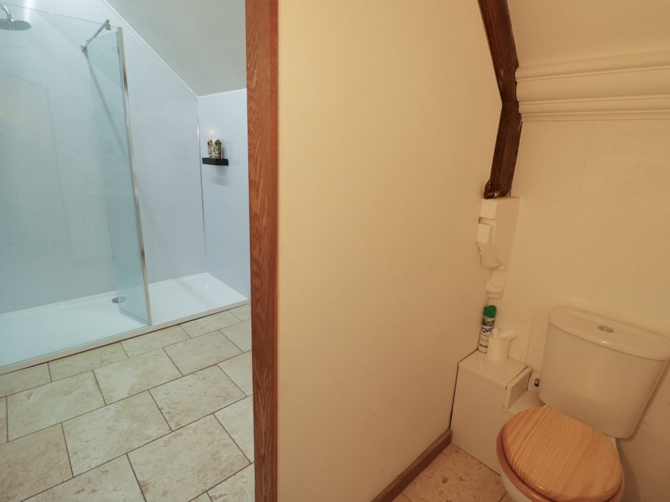 A bathroom featuring a shower and toilet at Talbot Lodge Ingestre near Great Haywood