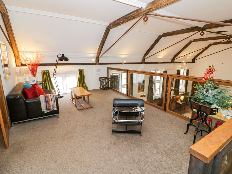 A loft with seating and a coffee table at Talbot Lodge Ingestre near Great Haywood