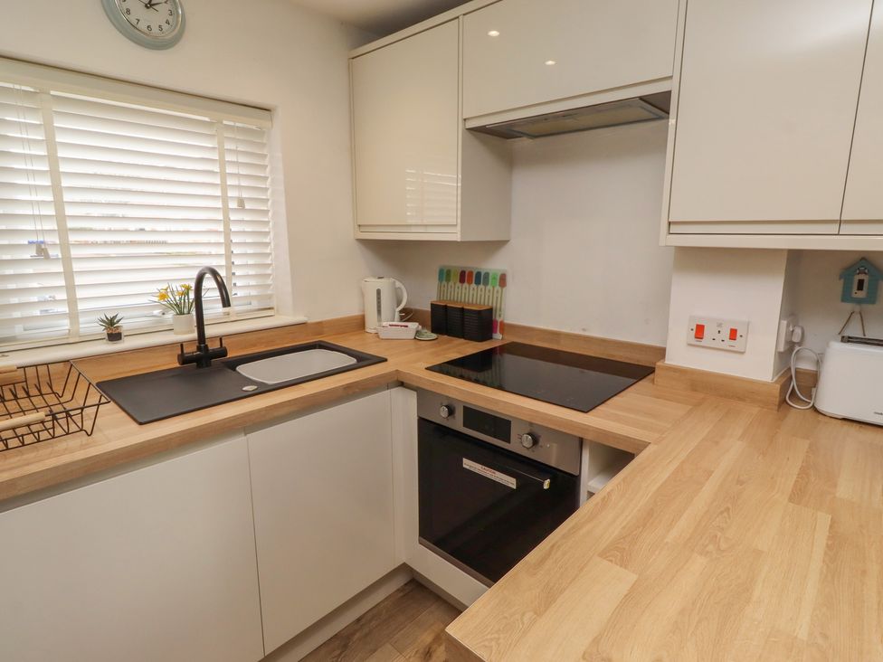 A kitchen featuring a sink, cooktop, and oven at 22 Longstone Park Beadnell