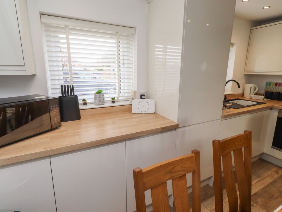 A kitchen with a microwave and sink at 22 Longstone Park Beadnell