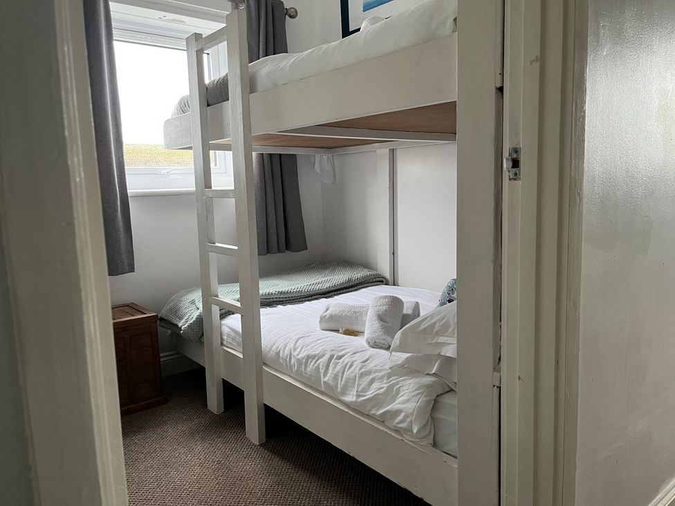 A bunk bed and twin bed in a bedroom at 22 Longstone Park Beadnell