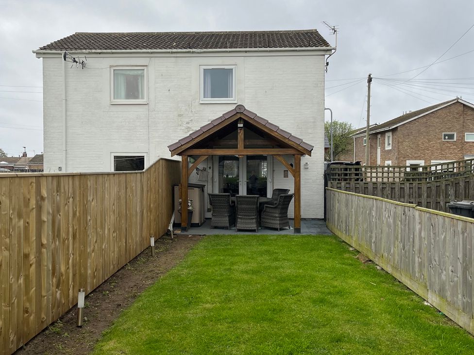 A house with a garden and patio area at 22 Longstone Park Beadnell