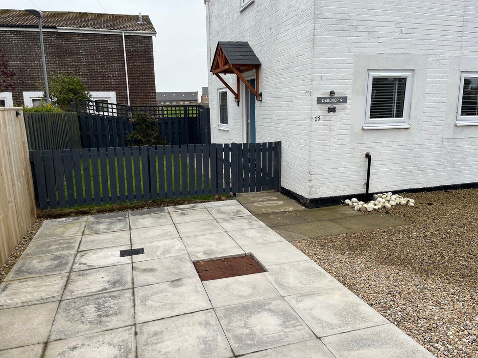 An outdoor area with a fence and pathway at 22 Longstone Park Beadnell