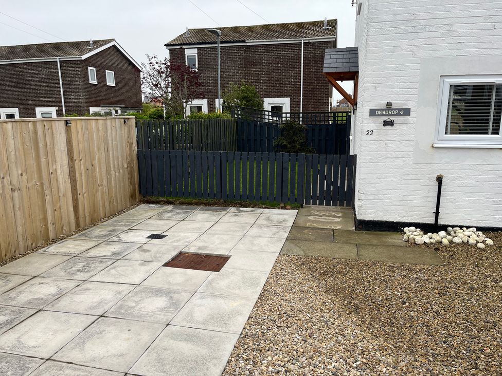 An outdoor area with a patio and gravel at 22 Longstone Park Beadnell