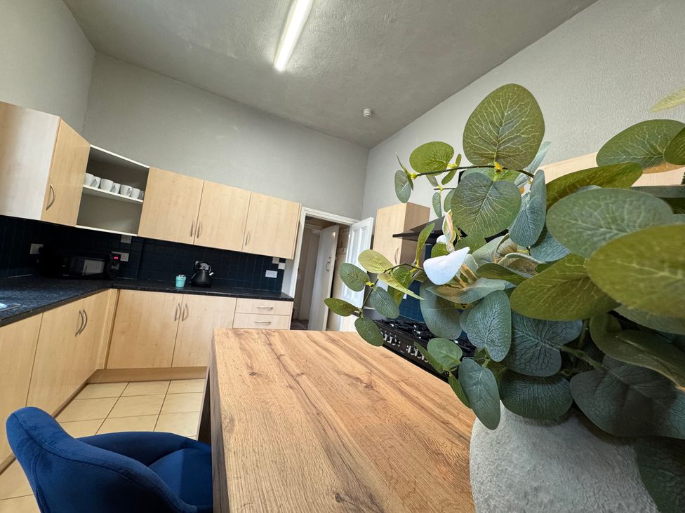 A kitchen with cabinets and a counter at The Causeway in 