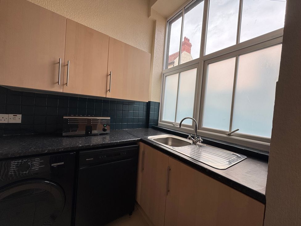 A kitchen with a sink and appliances at The Causeway 