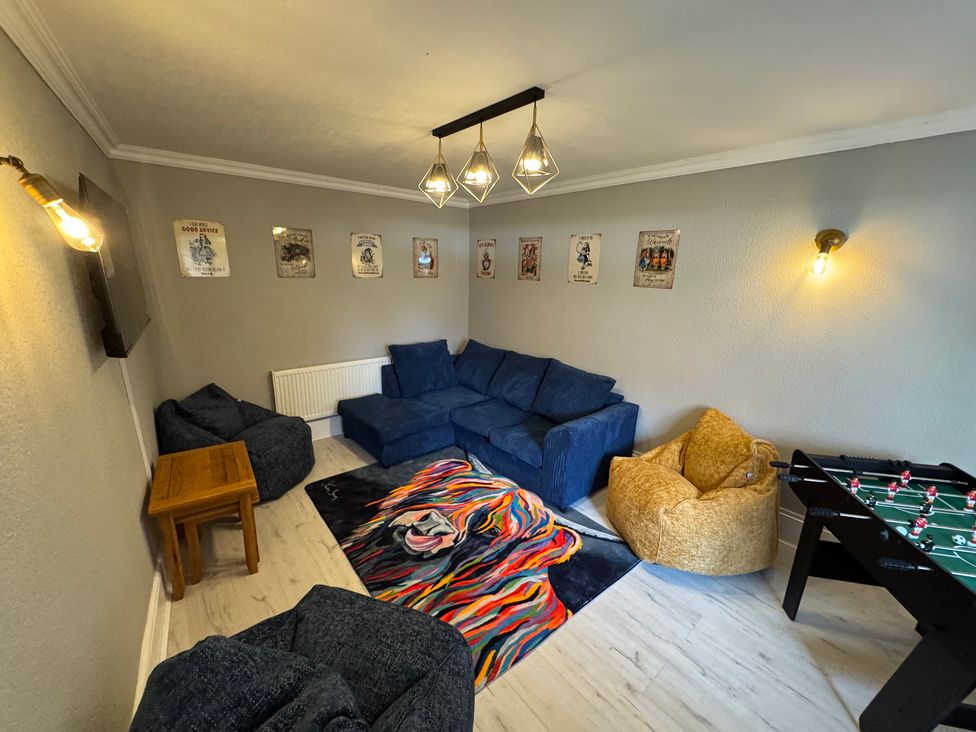 A snug with a sofa, bean bags, table and a foosball table at The Causeway