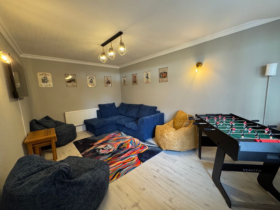 A snug with a sofa and a foosball table at The Causeway