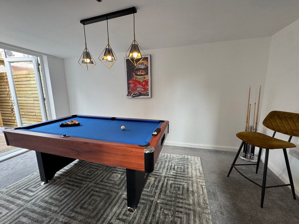 A game room with a pool table and pendant lights at The Causeway