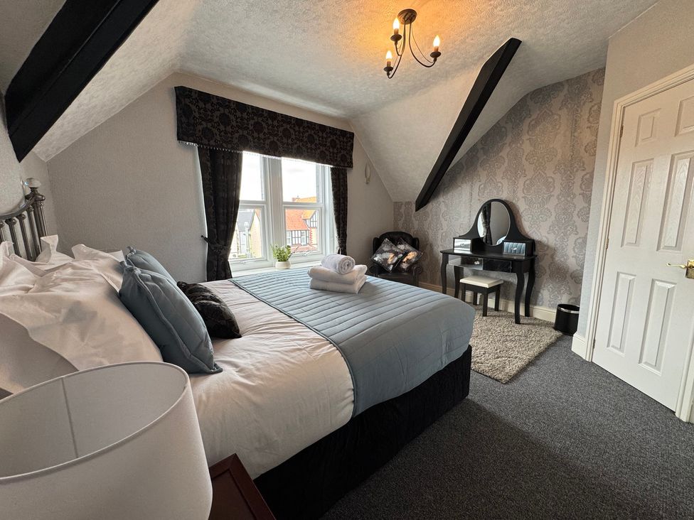 A bedroom with a bed and a mirror at The Causeway in 