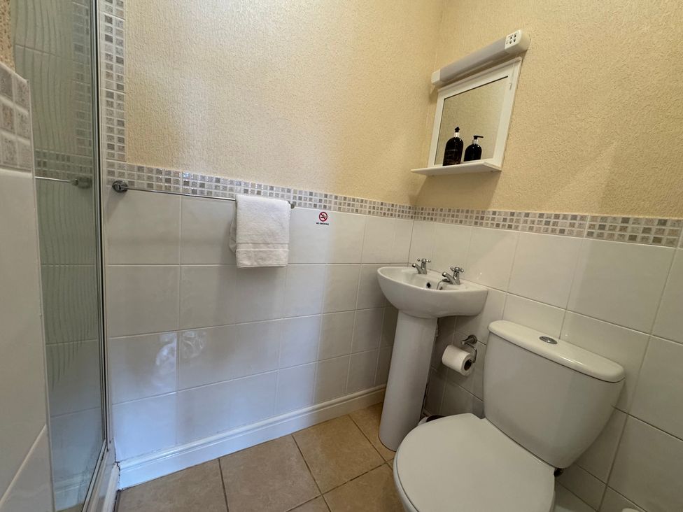 A bathroom with a shower, sink, and toilet at The Causeway