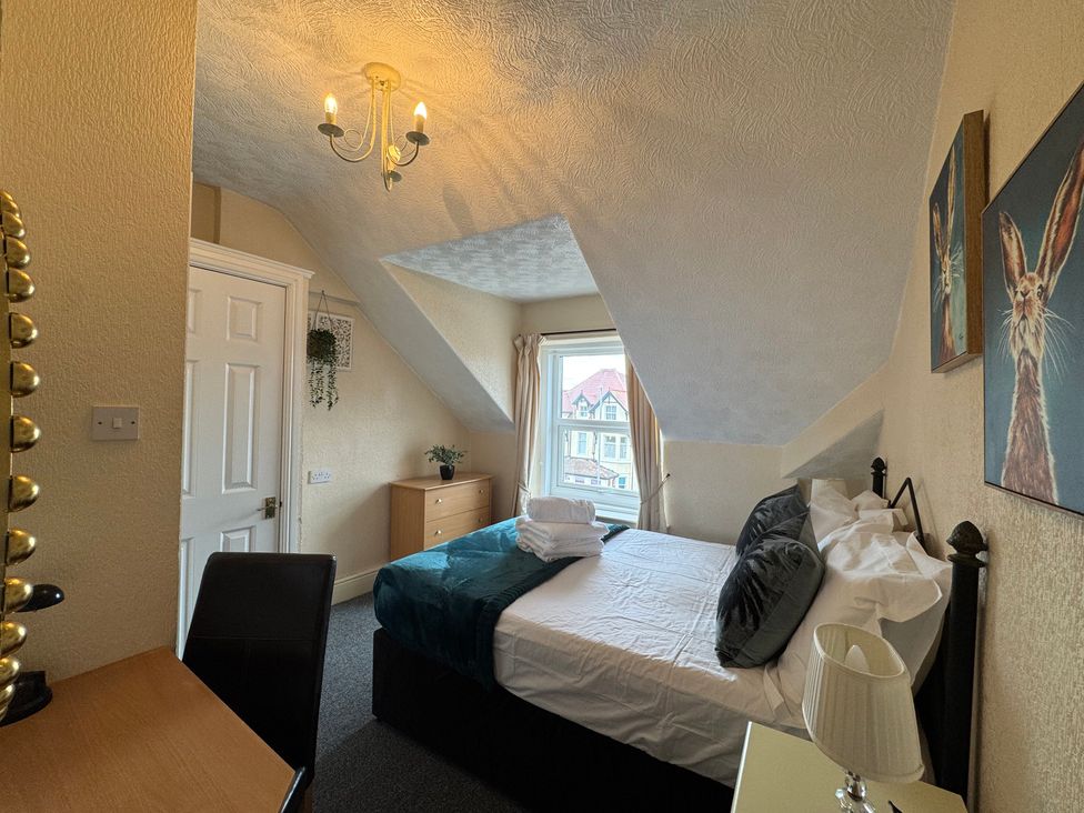 A bedroom with a bed and desk at The Causeway 