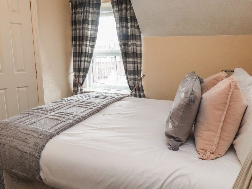 A bedroom with a bed and pillows at The Causeway in Llandudno