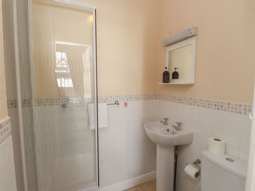 A bathroom with shower, sink, and toilet at The Causeway in Llandudno