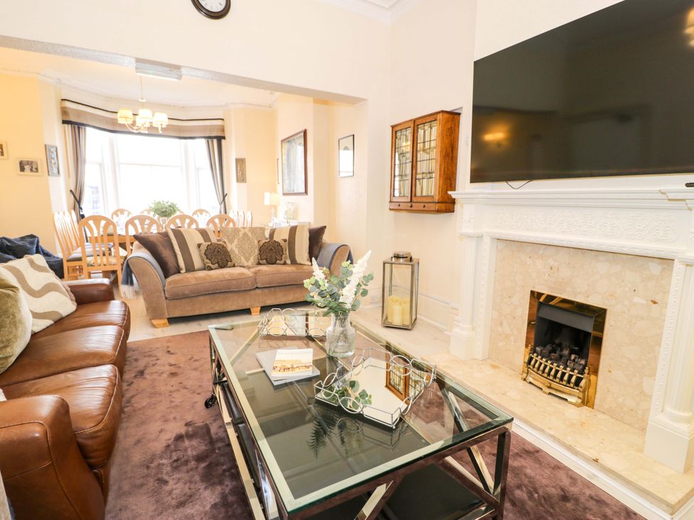 A living room with a sofa and coffee table at The Causeway in Llandudno