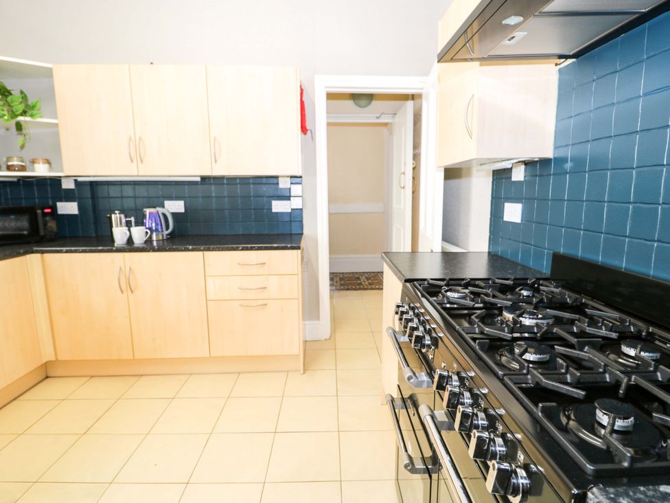 A kitchen with cabinets and a stove at The Causeway in Llandudno