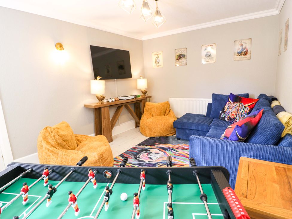A snug with a foosball table and a television at The Causeway in Llandudno