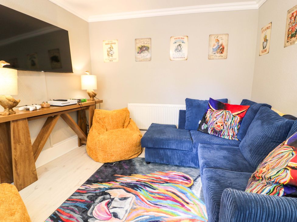 A living room with a sofa and television at The Causeway in Llandudno