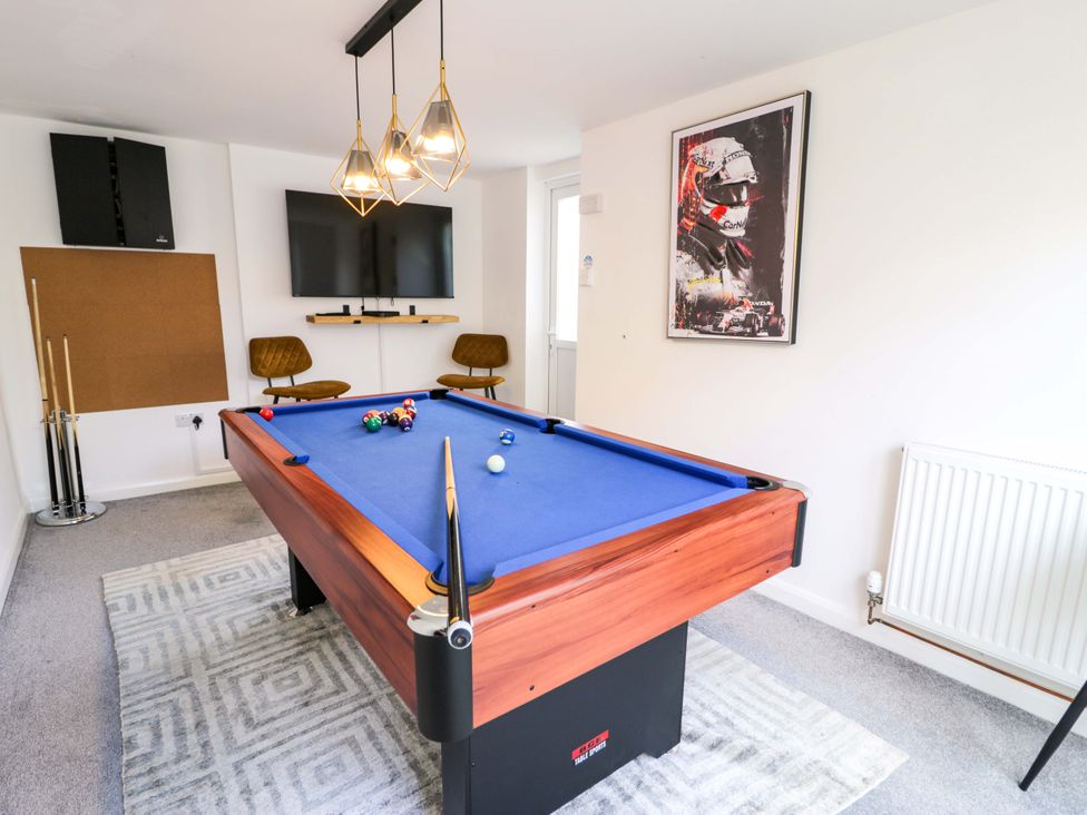 A game room with a pool table and television at The Causeway in Llandudno