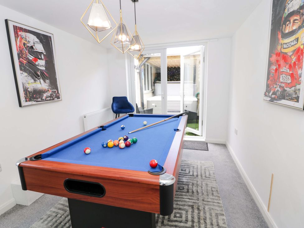 A game room with a pool table and artwork at The Causeway in Llandudno