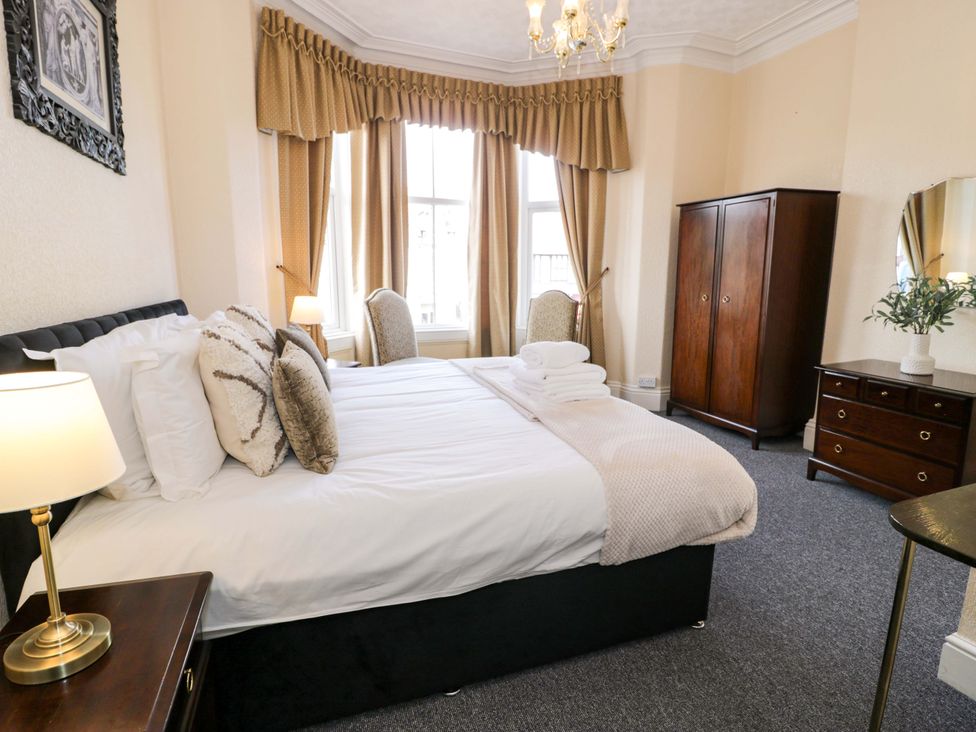 A bedroom with a bed and wardrobe at The Causeway in Llandudno