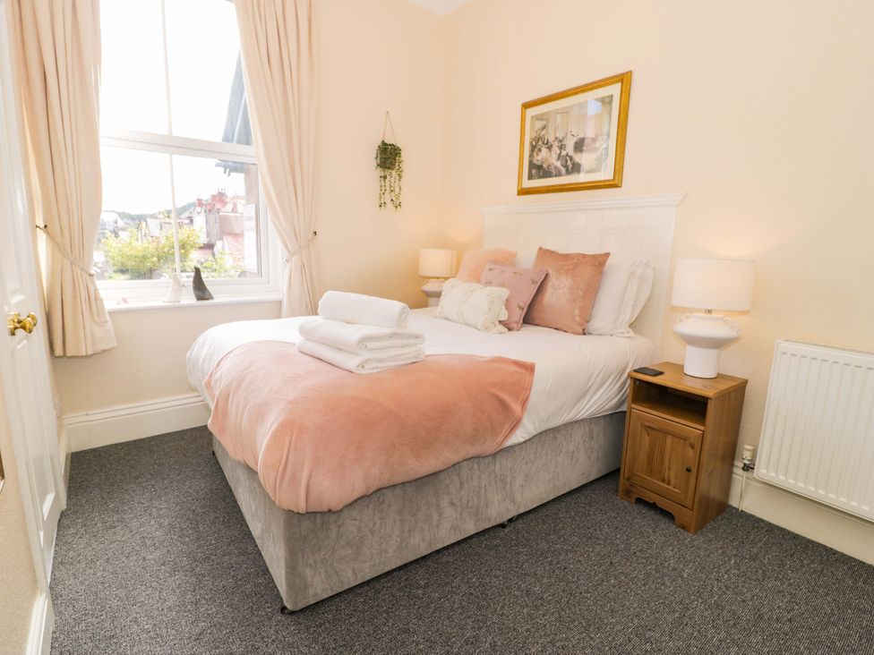 A bedroom with a bed and nightstand at The Causeway in Llandudno
