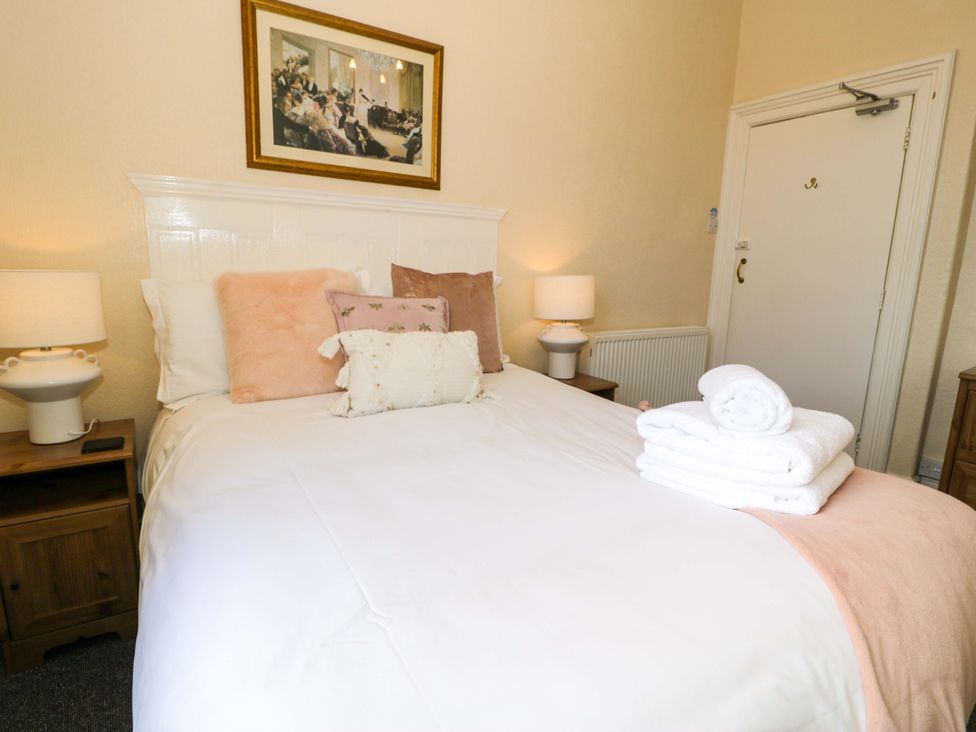 A bedroom with a bed and pillows at The Causeway in Llandudno