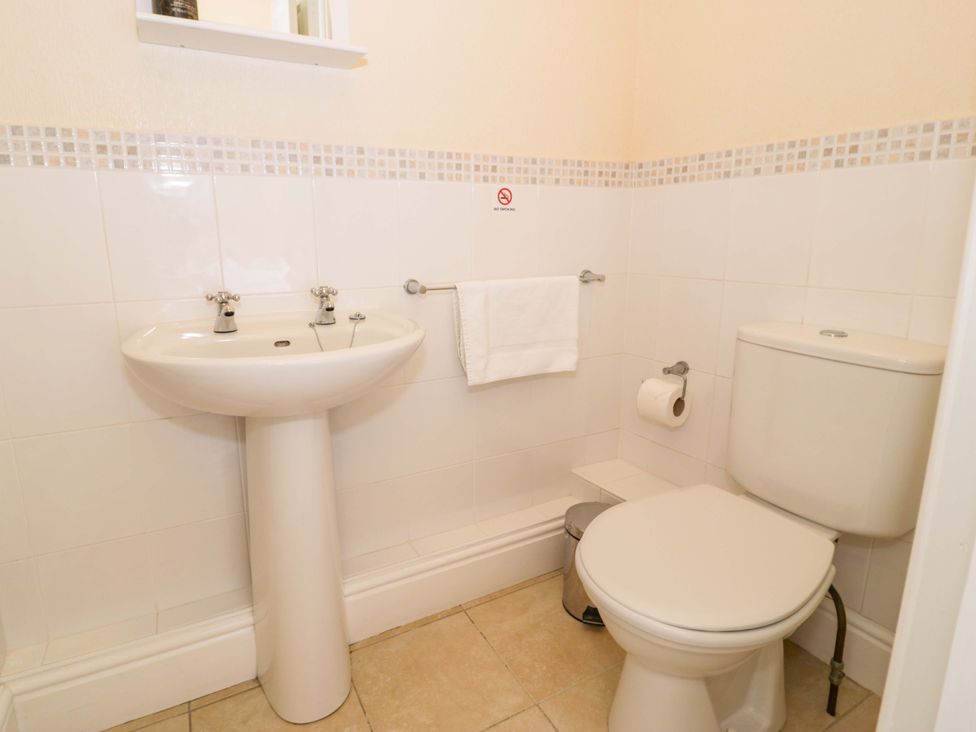 A bathroom with a sink and toilet at The Causeway in Llandudno