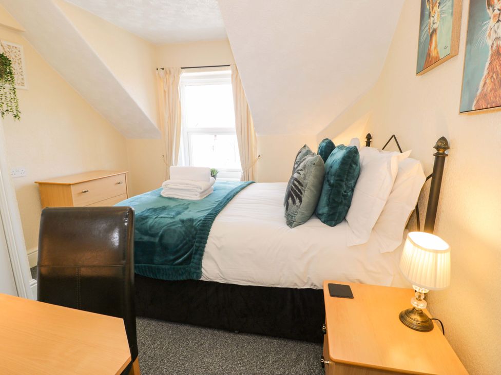 A bedroom with a bed and a desk at The Causeway in Llandudno