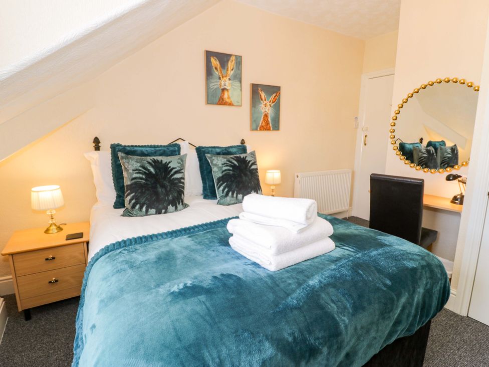 A bedroom with a bed and bedside table at The Causeway in Llandudno