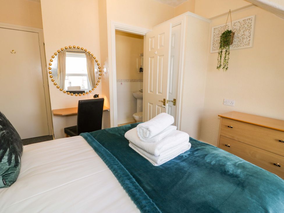 A bedroom with towels on the bed at The Causeway in Llandudno
