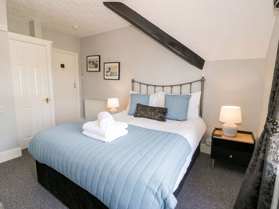 A bedroom with a bed and bedside table at The Causeway in Llandudno