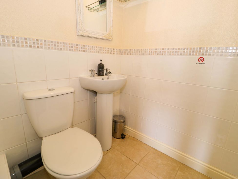 A bathroom with a toilet and sink at The Causeway in Llandudno