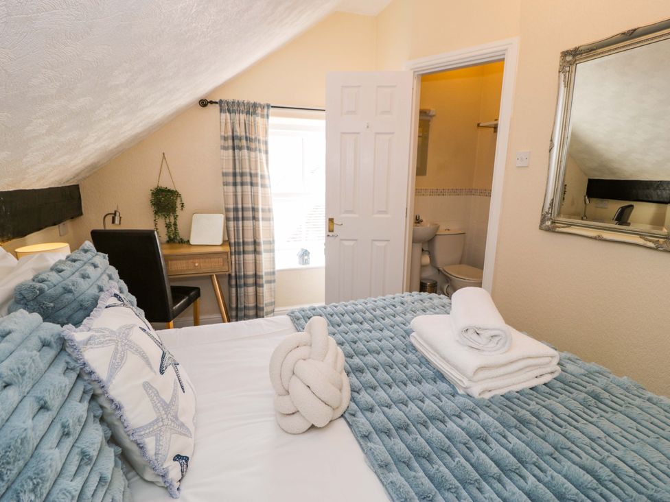 A bedroom with a bed and desk at The Causeway in Llandudno