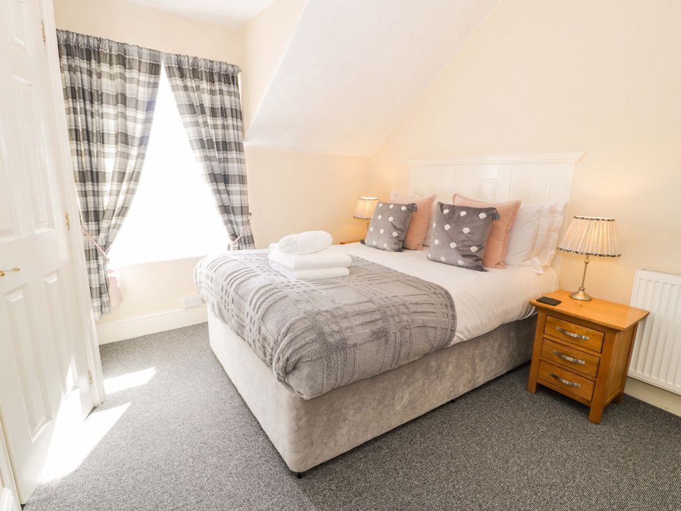 A bedroom with a bed and bedside table at The Causeway in Llandudno