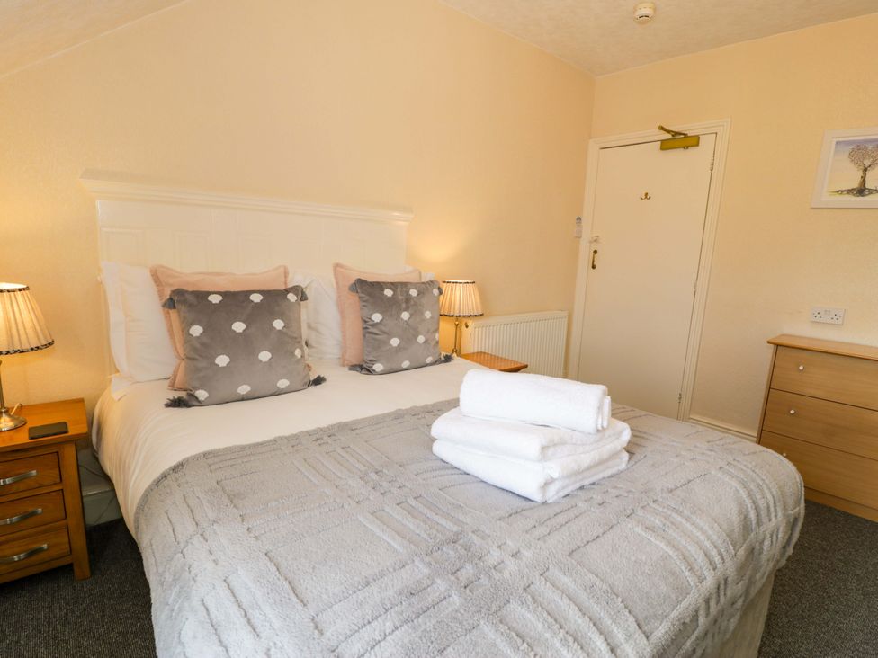 A bedroom with a double bed and bedside tables at The Causeway in Llandudno