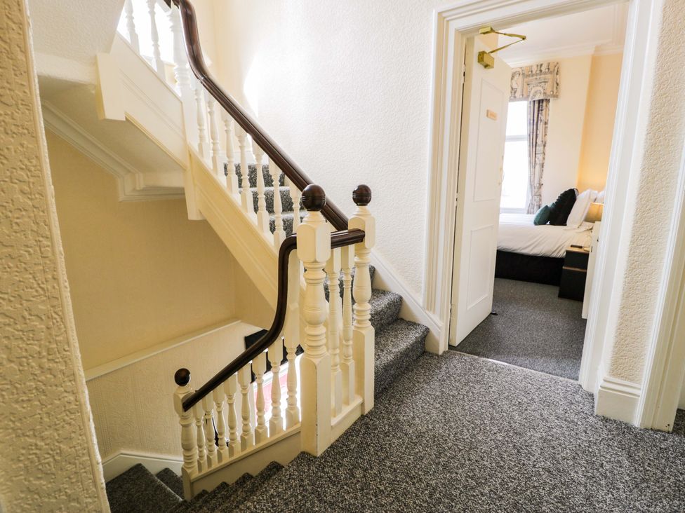 A staircase leading to a door at The Causeway in Llandudno
