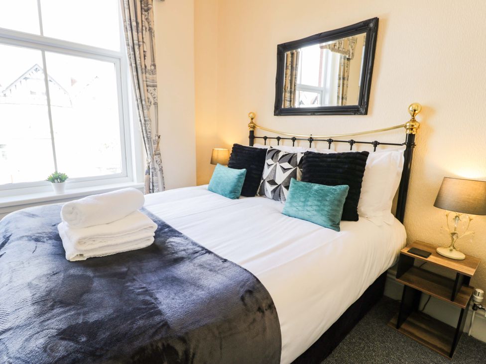 A bedroom with a bed and pillows at The Causeway in Llandudno