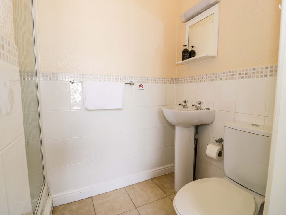 A bathroom with a shower enclosure and a wash basin at The Causeway in Llandudno