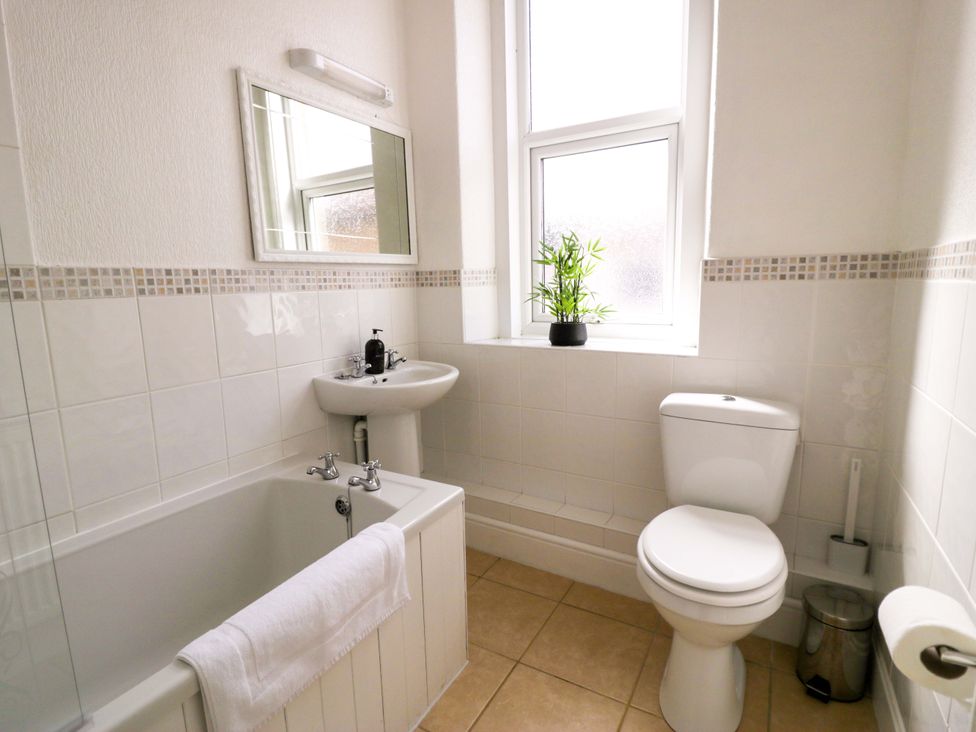 A bathroom with a bathtub, sink, and toilet at The Causeway in Llandudno