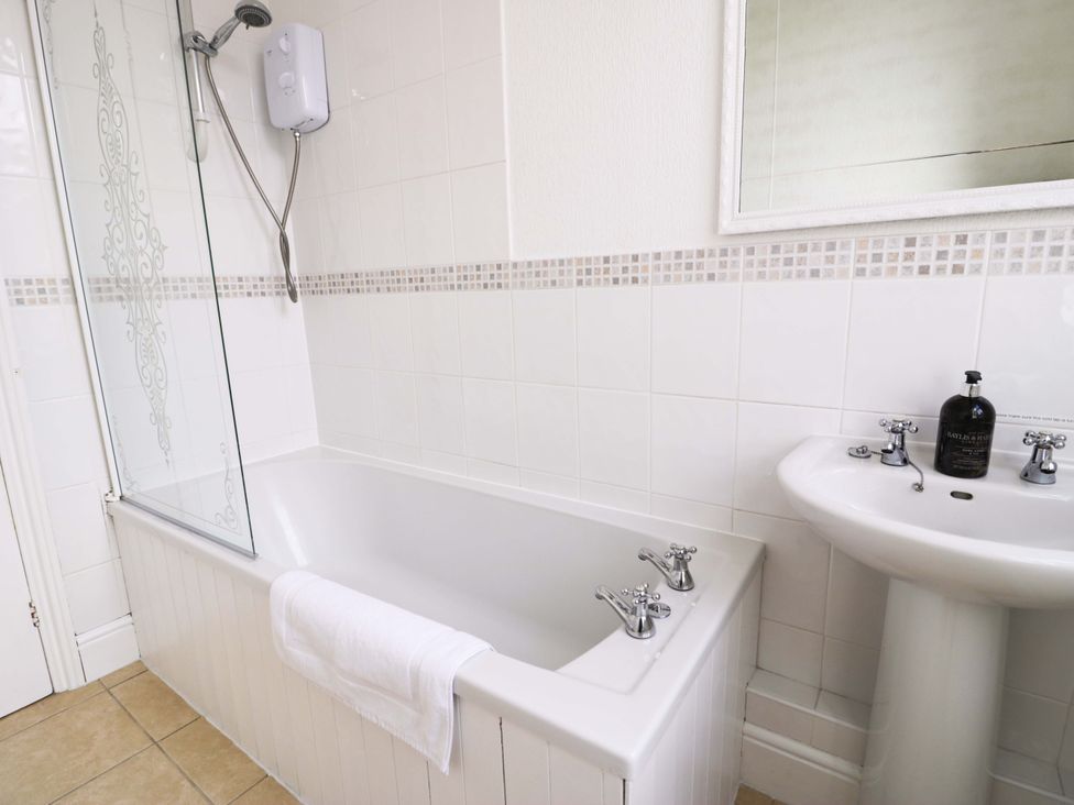A bathroom with a bathtub and sink at The Causeway in Llandudno