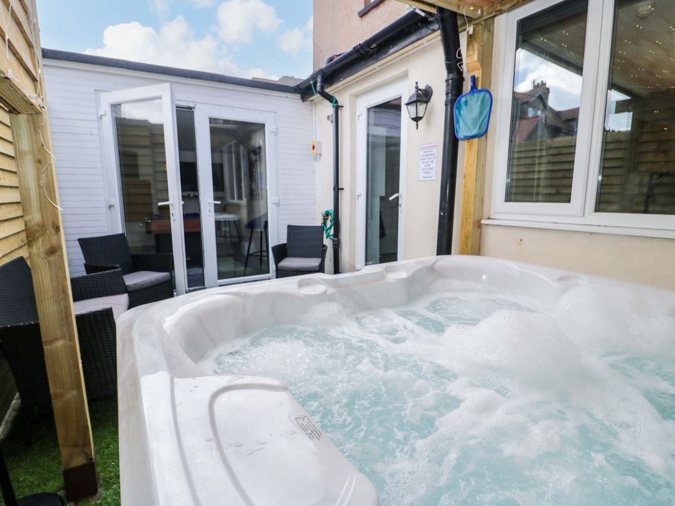 An outdoor area with a hot tub and seating at The Causeway in Llandudno