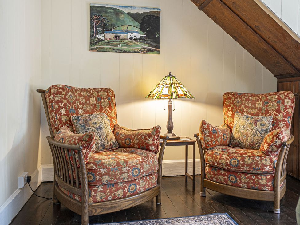 A sitting room with two armchairs and a lamp at Primrose Spinney Highwood near Ringwood