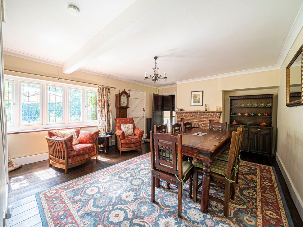 A dining room with a table and chairs at Primrose Spinney in Highwood near Ringwood