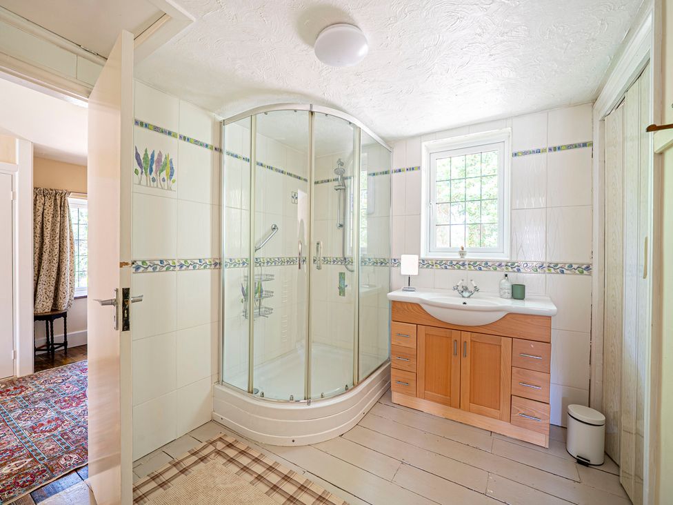 A bathroom with a shower and sink at Primrose Spinney Highwood near Ringwood