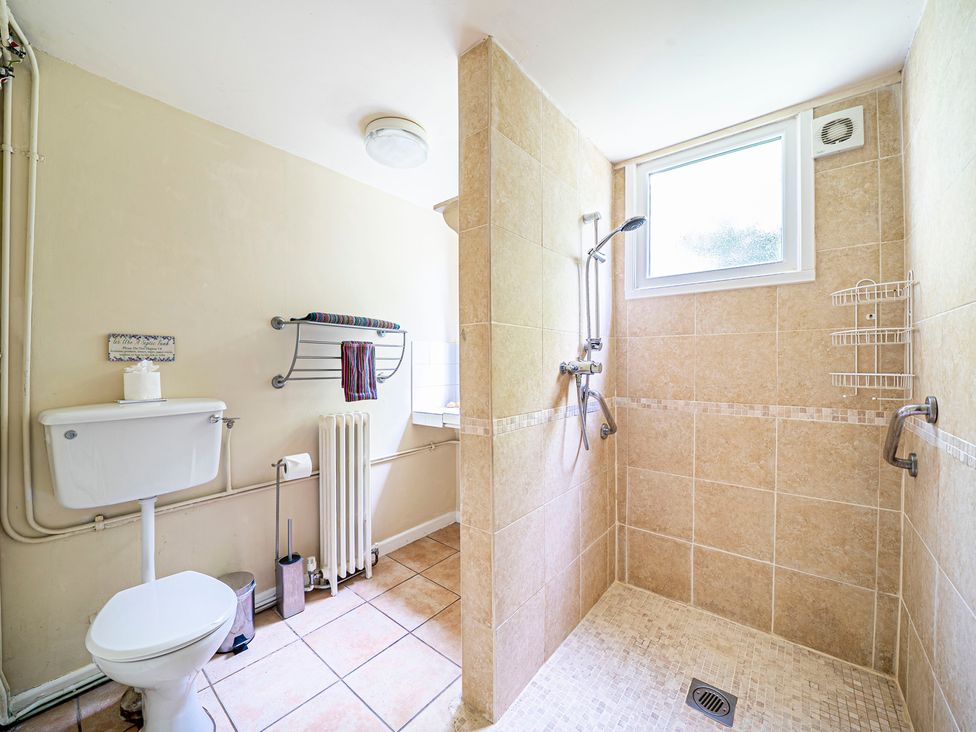 A bathroom with a shower and toilet at Primrose Spinney in Highwood near Ringwood