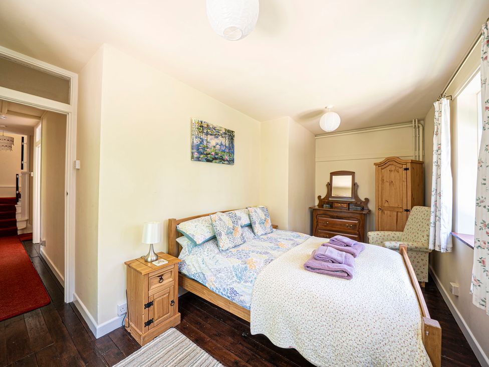 A bedroom with a bed and wardrobe at Primrose Spinney in Highwood near Ringwood