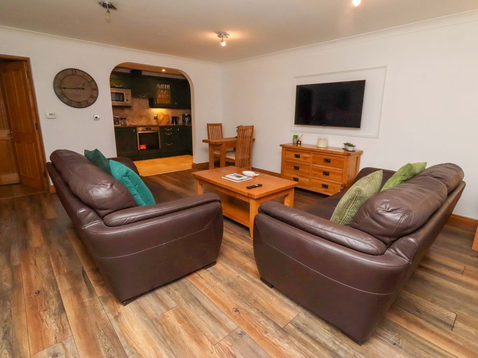 A living room with sofas and a television at 1 Pear Tree in Beadnell